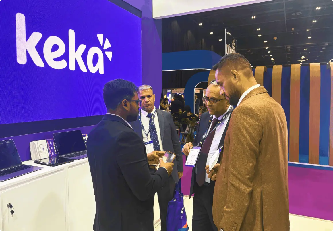 Visitors talking with the Keka team in front of the Keka display